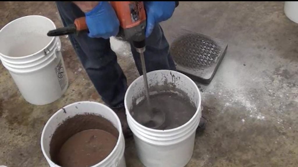Using a jiffy mixer to mix concrete