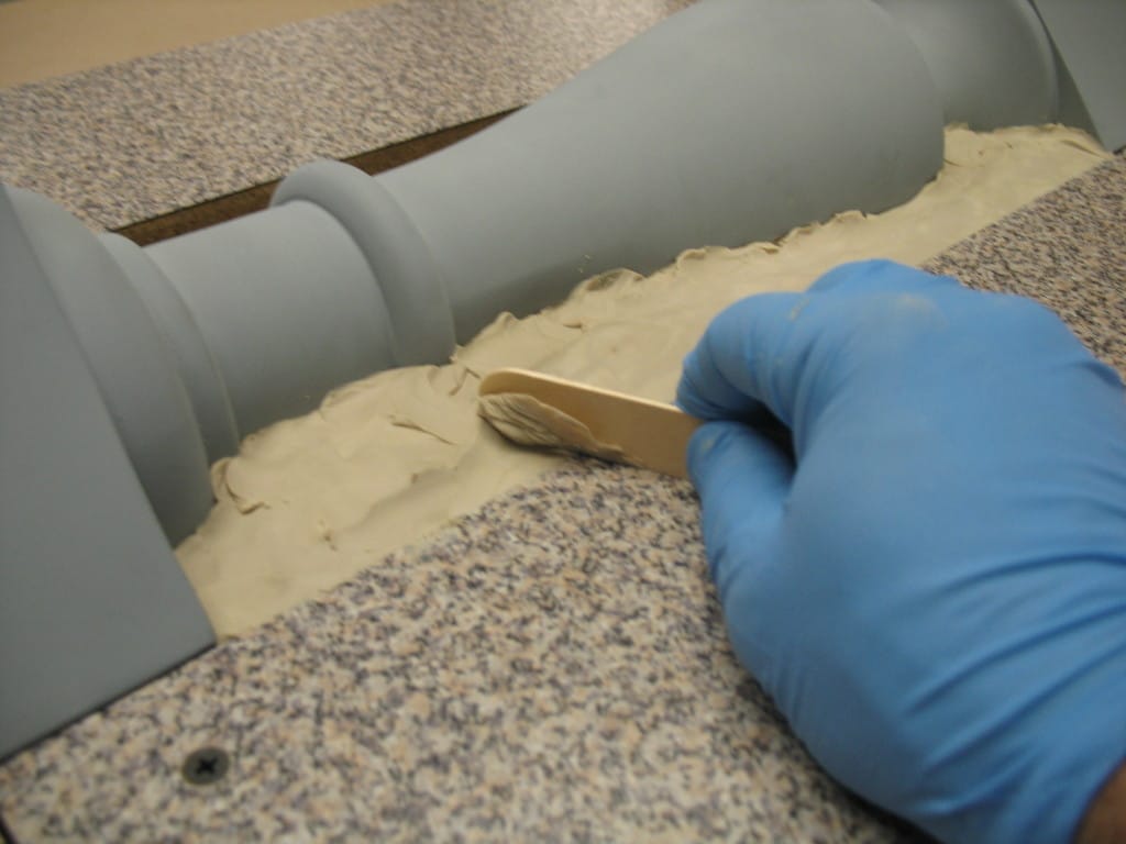 smooth clay with tongue depressor